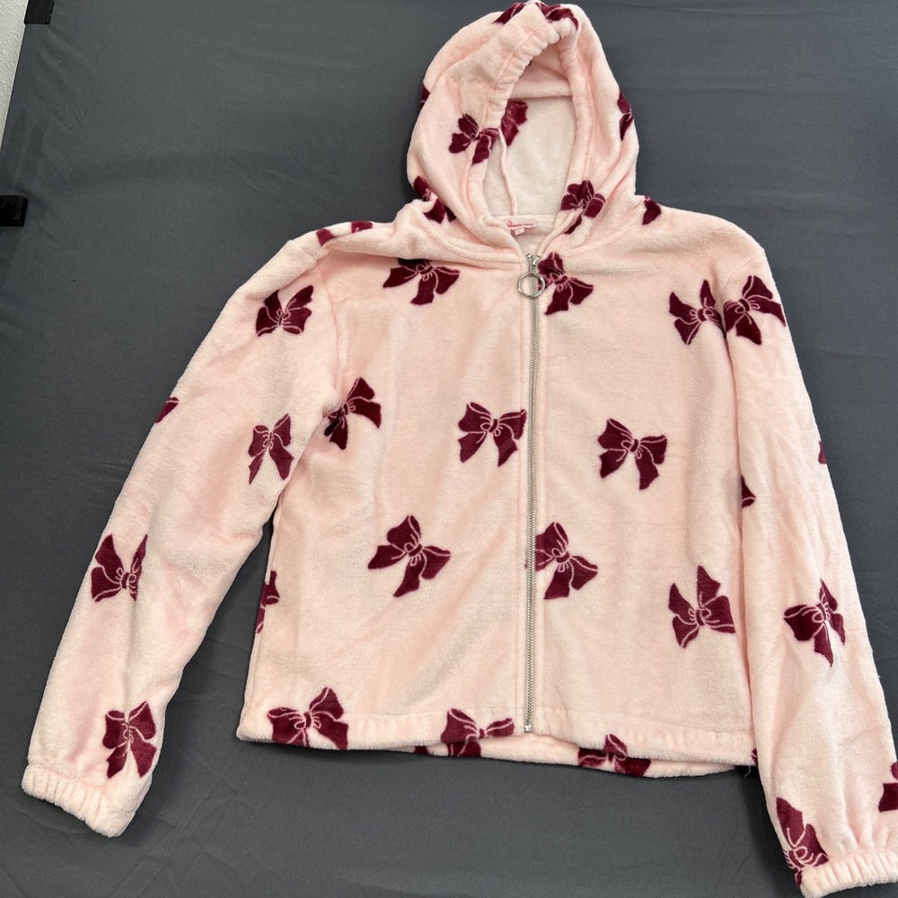 Angel Cult, featuring a dark red bow print and a silver circular zipper Large